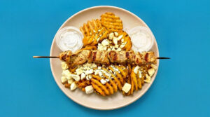 1/2 POUND LOADED CHICKEN SOUVLAKI FETA FRIES w/ 2 SIDES OF TZATZIKI
